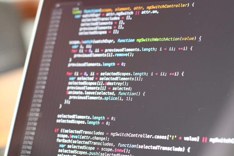 A close-up view of a computer screen displaying lines of colorful code, including variables, functions, and syntax highlighting, set against a blurred background. The screen appears to be part of a so